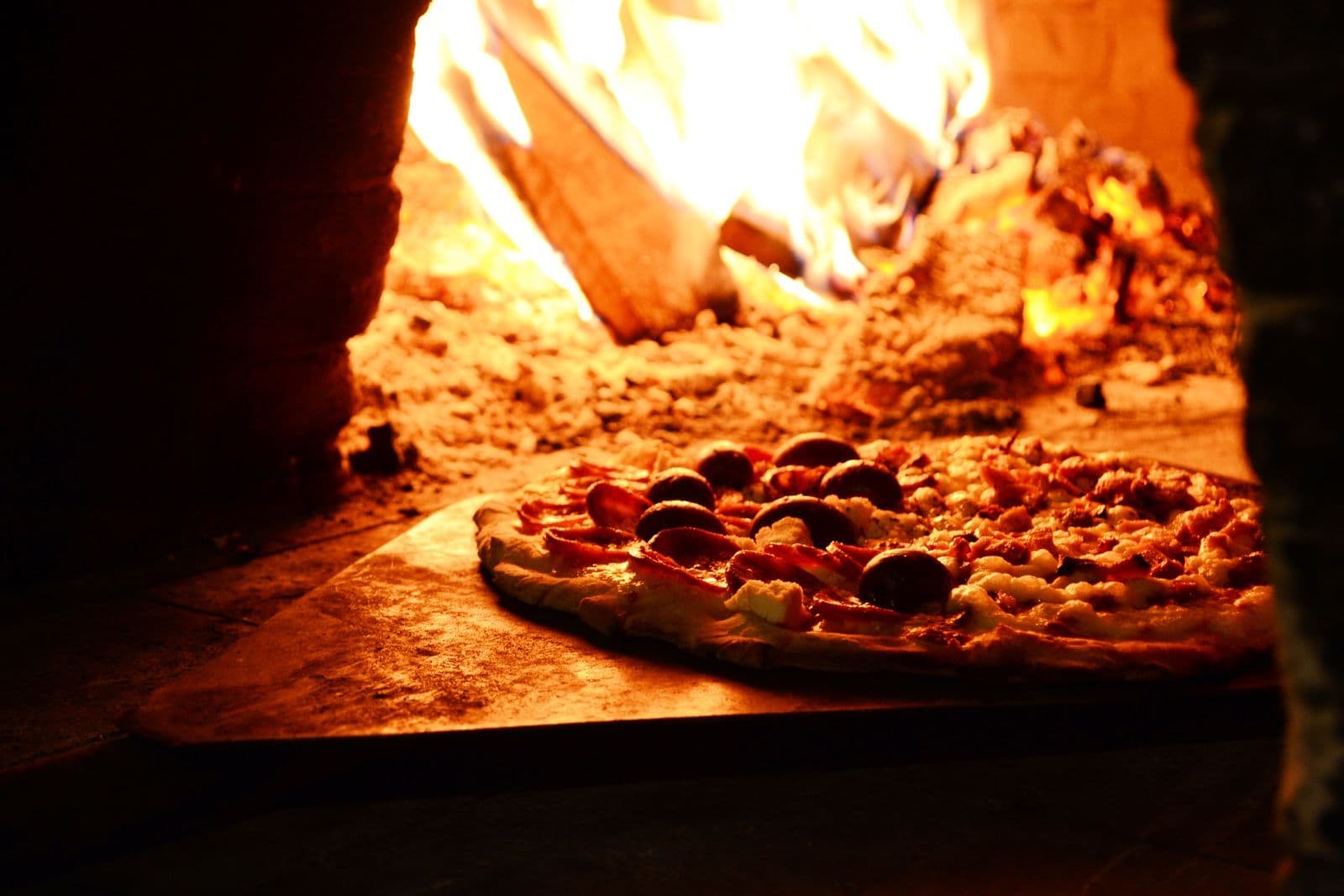Pizza in de houtgestookte steenoven